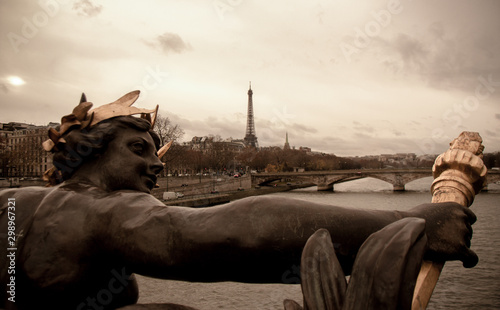 Bronze sculpture on a bridge and Eiffel Tower in Paris © AngelaCapitan