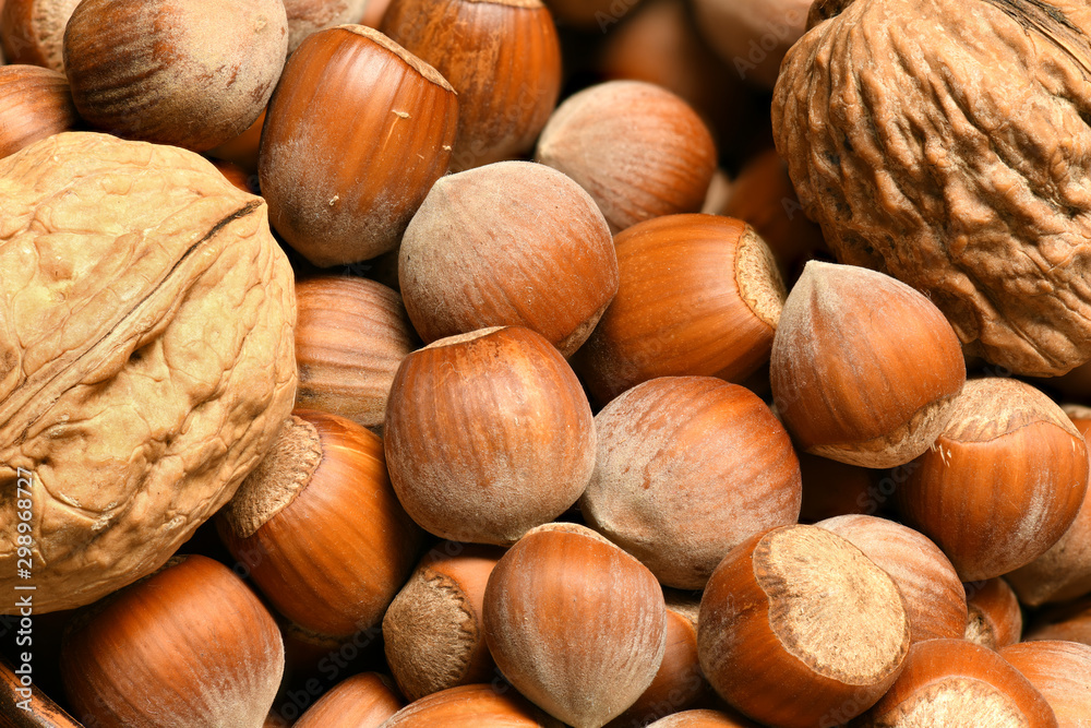macro photo of nuts and walnuts - autumn harvest and healthy food concept. Yellow leaves. Still life on wooden background. macro photo of nuts and walnuts - autumn harvest and healthy food concept. Yellow leaves. Still life on wooden background.