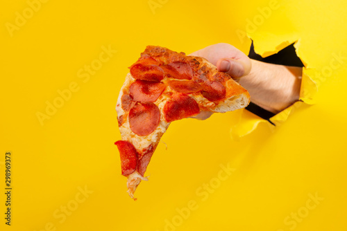 Hand giving slice of pizza