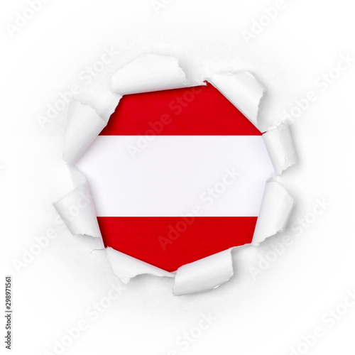 View of the austrian flag through the big breakthrough in the paper.