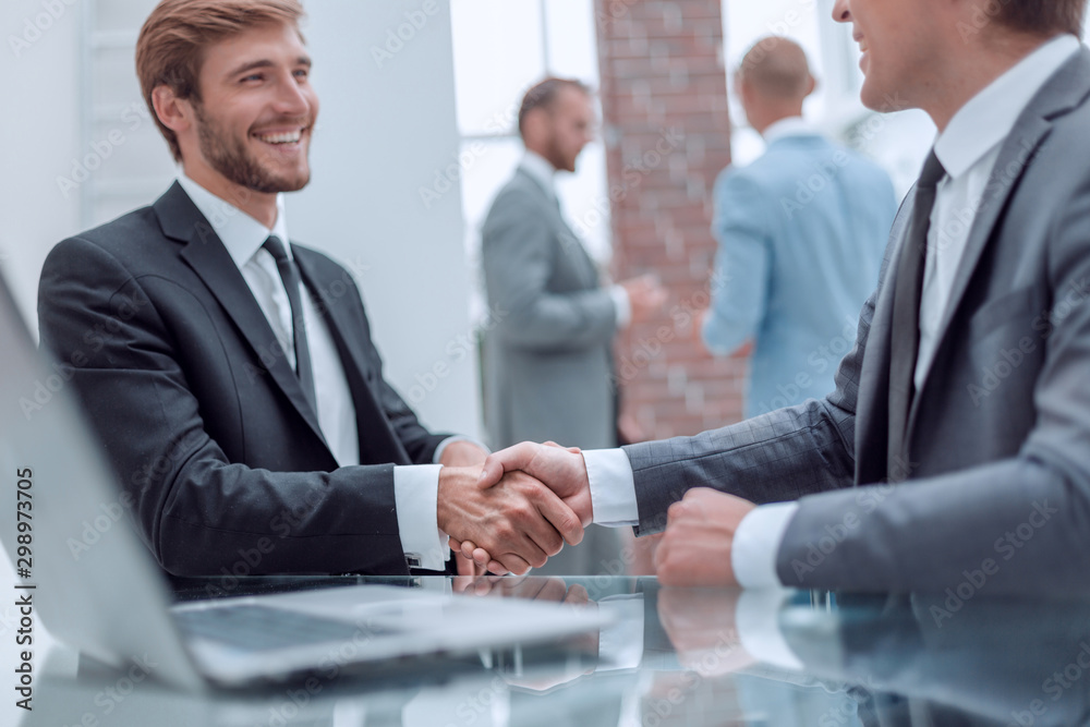 close up. handshake of business people near the office table close up. handshake of business people near the office table