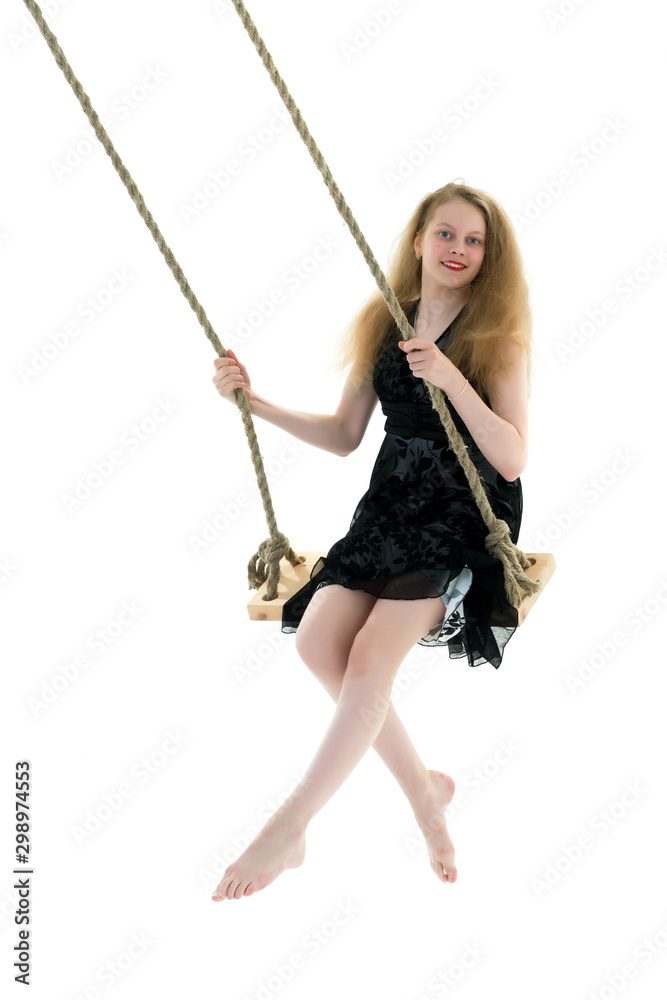 Beautiful teen school girl swinging on a swing. Concept summer v Beautiful teen school girl swinging on a swing. Concept summer v