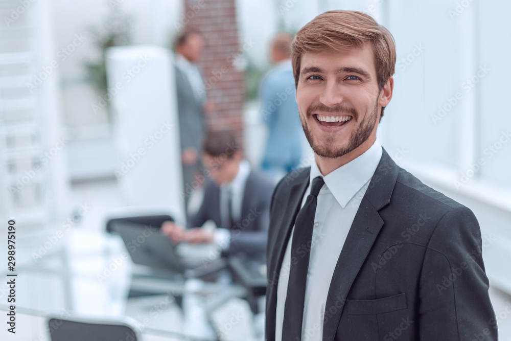 close up. smiling businessman standing in his office. close up. smiling businessman standing in his office.