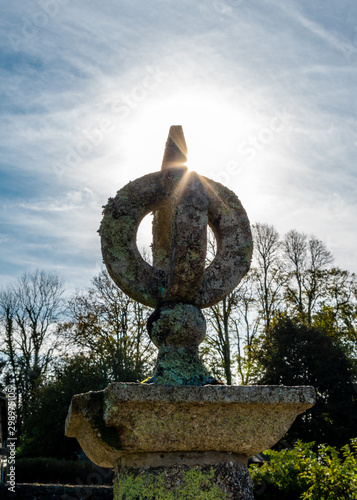 Autumn Sun Peeks over a Spherical Garden Monument at Ancient Monument at Buckland Abbey, Devon photo