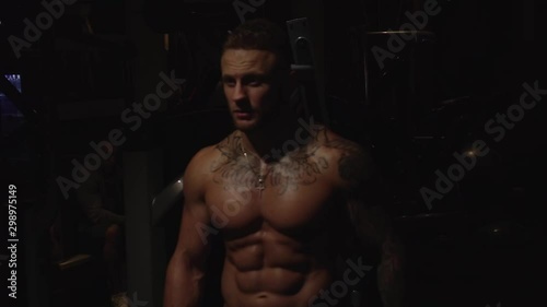 Fit guy comes out from darkness, slow motion, 250 fps