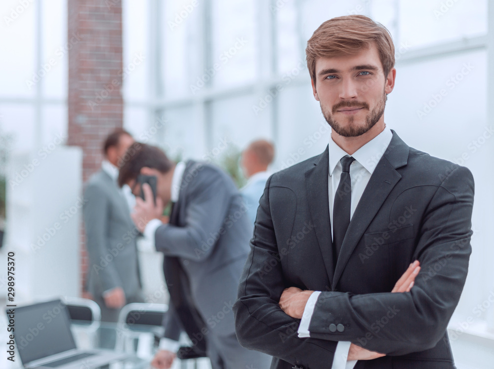 Fototapeta premium confident young businessman standing in the office