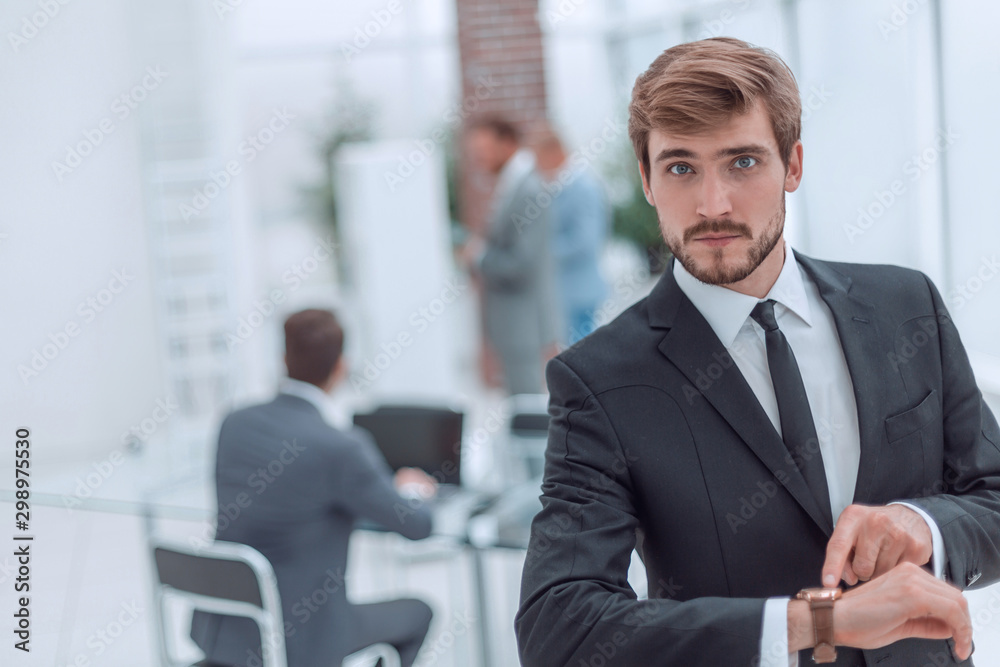 serious businessman pointing to his wrist watch. serious businessman pointing to his wrist watch.