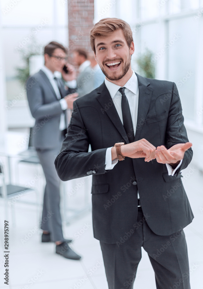 friendly young businessman standing in the office.