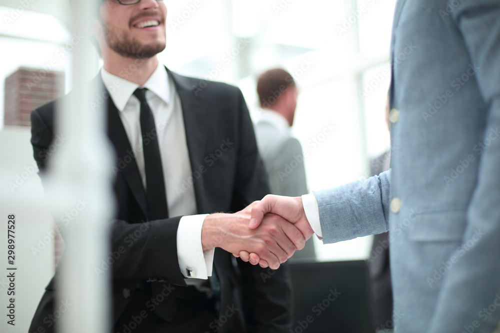 smiling businessman shaking hands with his business partner smiling businessman shaking hands with his business partner