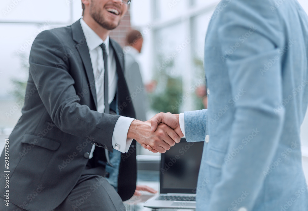 close up. business handshake on the background of the office. close up. business handshake on the background of the office.