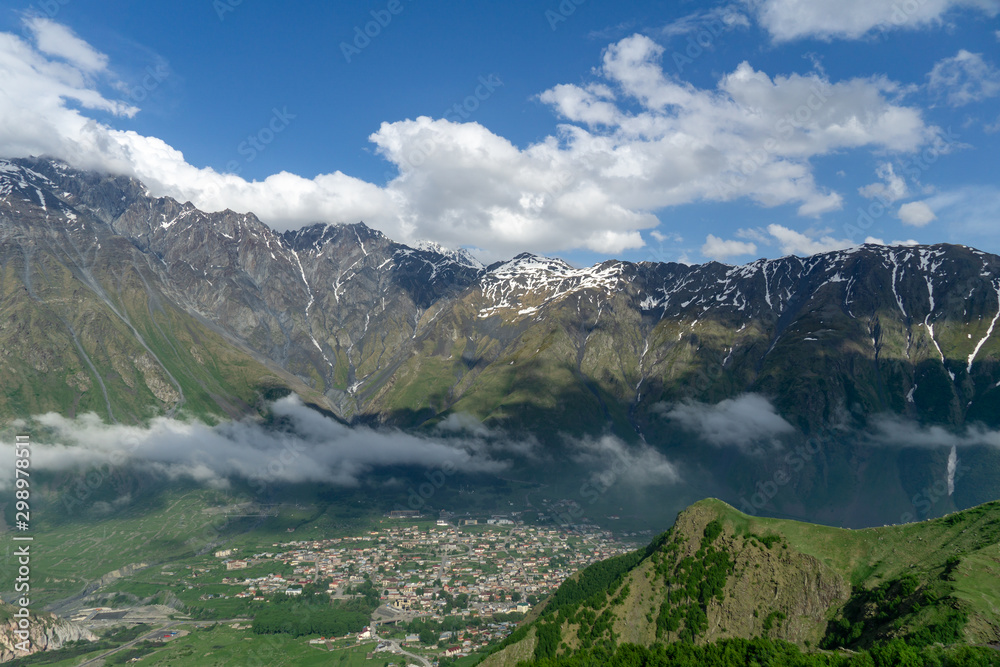 Panoramic beautiful view of the Stepantsminda village in the mountains Panoramic beautiful view of the Stepantsminda village in the mountains