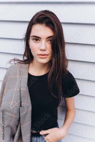 Free Download Close up portrait of young hipster modern young brunette girl posing in trendy casual coat on wooden white background. Fashion, modeling, natural beauty concept - GFXLoad