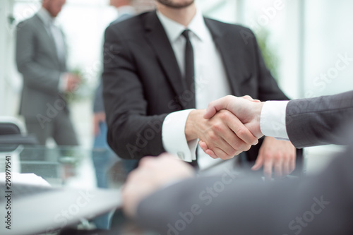 close up. smiling Manager shaking hands with the client © ASDF