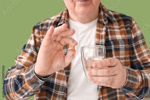 Elderly man taking medicine...