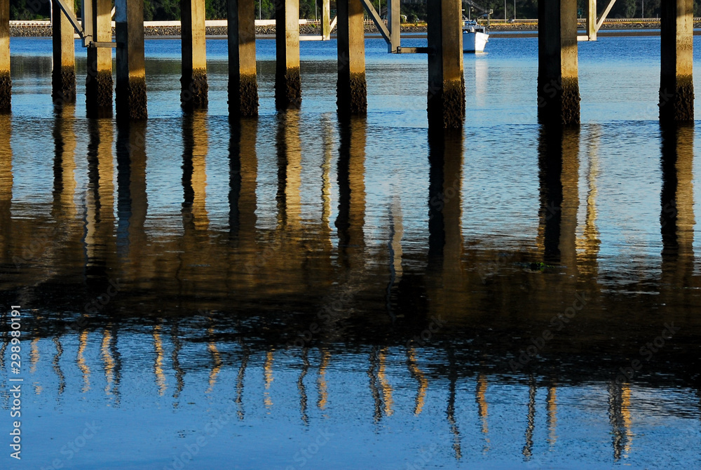 Reflection of the dock structure in the water, Tauranga, New Zealand