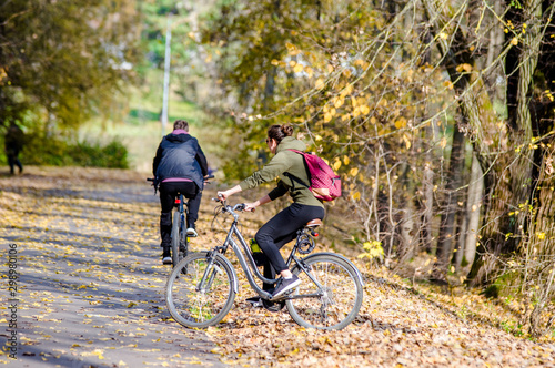 Cyclists ride on the bike path in the city Park 