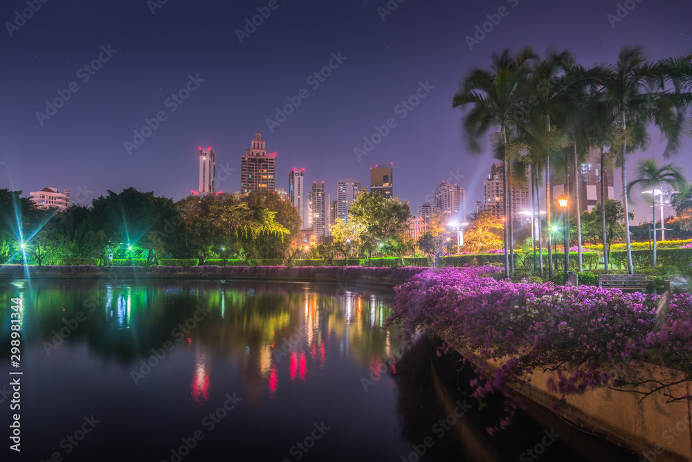 Lake with Calm Water Reflecting Nearby Buildings in South Part of Benjakiti Public Park at Night in Bangkok, Thailand