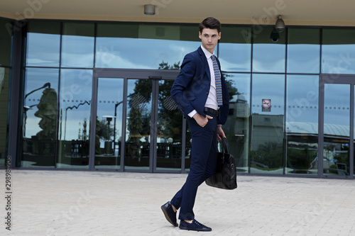 Young businessman in blue suit and tie in and around the conference hall in Sochi