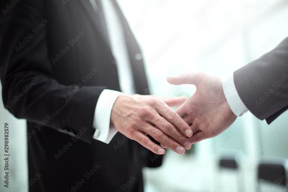 image of business people holding out their hands for a handshake.