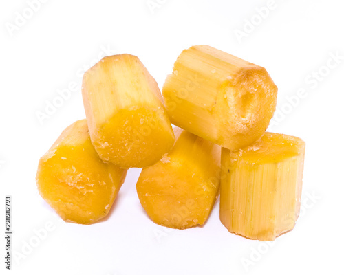 Studio shot five peeled sugar cane sticks isolated on white