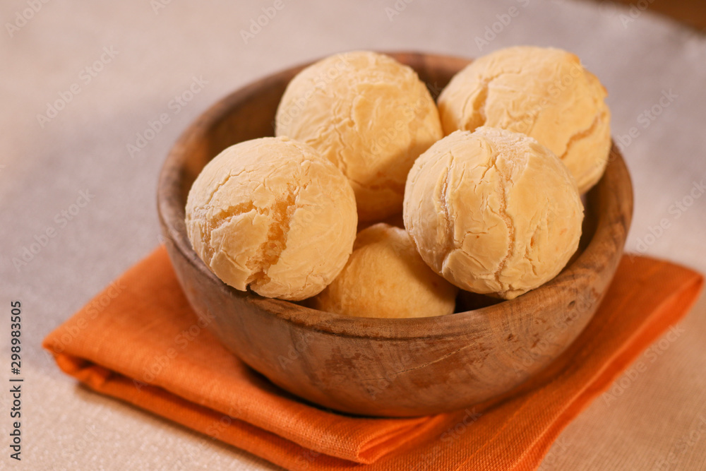 Pao de Queijo on wooden Bowl. Traditional cheese bread (pão de queijo) bowl on a table Pao de Queijo on wooden Bowl. Traditional cheese bread (pão de queijo) bowl on a table