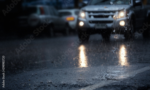 Hard rain fall in the city with blurry cars .Selective focus.