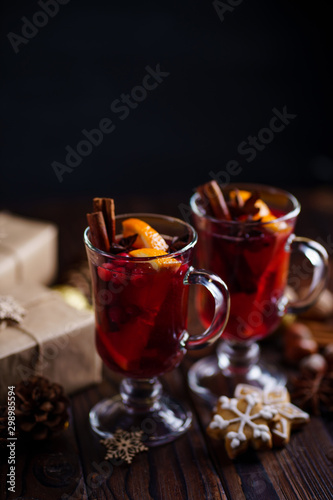 Christmas holidays atmosphere, cold winter day. Warming mood. Mulled wine with cranberry, cinnamon, orange and anise.