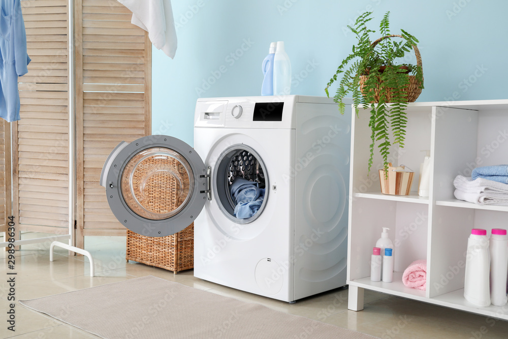 Interior of home laundry room with modern washing machine - obrazy, fototapety, plakaty 