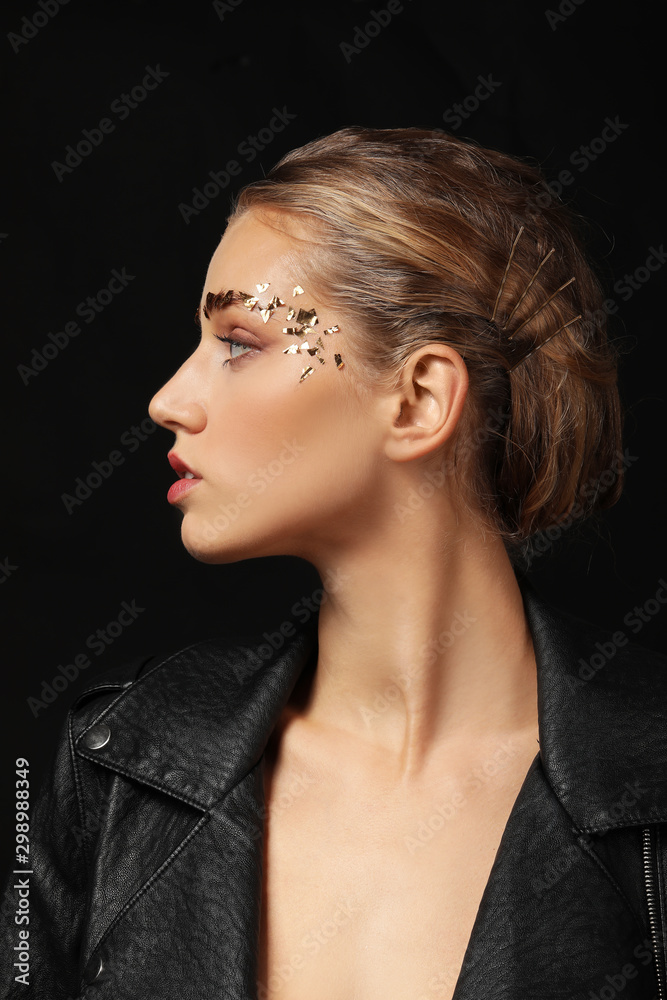 Fototapeta premium Young woman with creative eyebrows on dark background