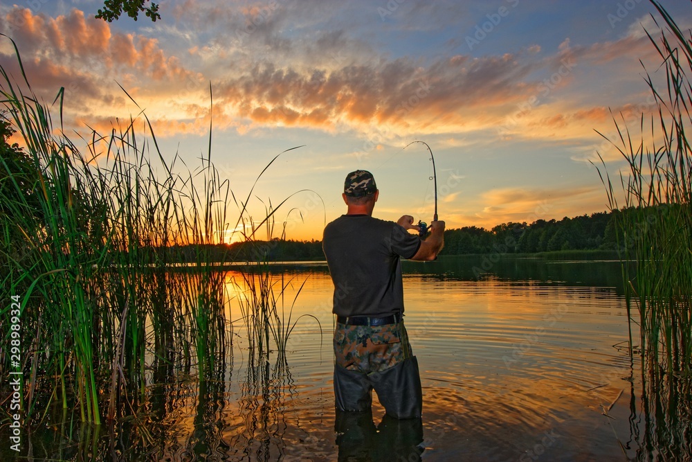 Fisherman catching the fish during sunset Fisherman catching the fish during sunset