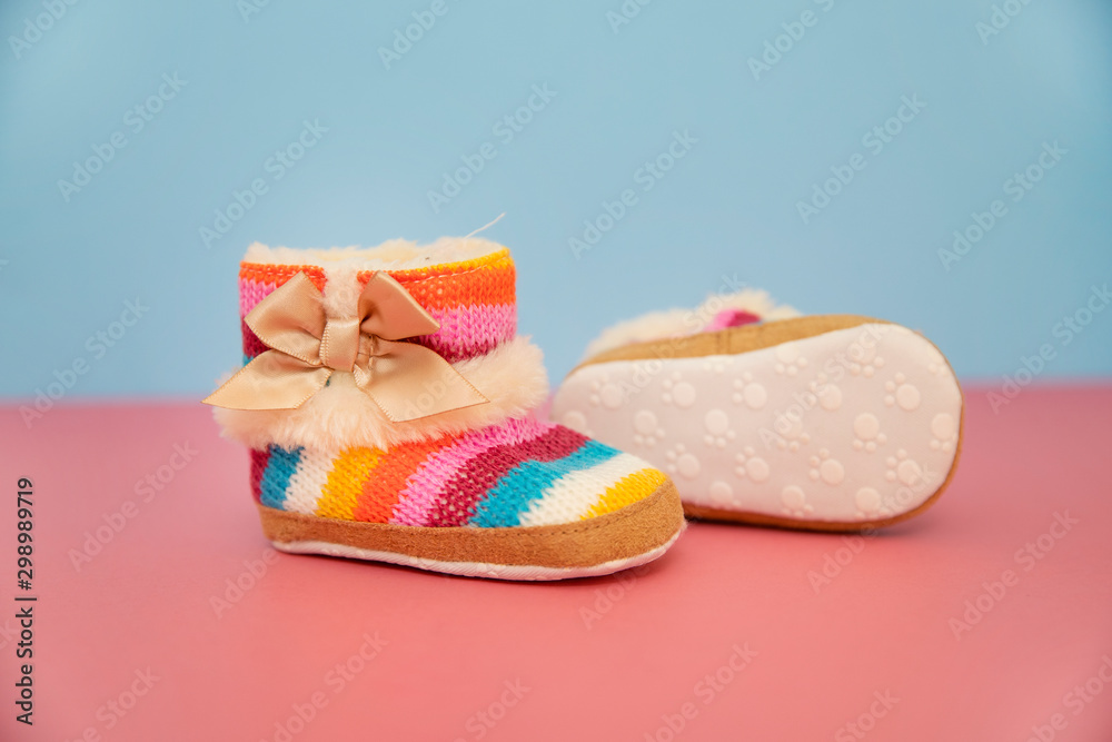 colorful baby boots on pink and blue background colorful baby boots on pink and blue background