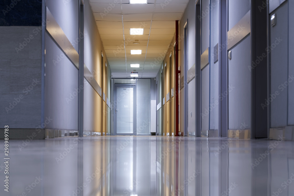 Corridor: floor, ceiling and walls of an office building. Work and business. Interior. An example of installed sockets, switches and smoke detectors