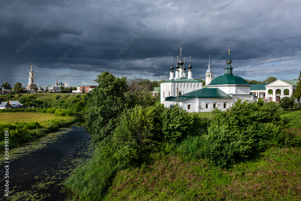 Russia, Vladimir Oblast, Golden Ring, Suzdal: Panorama view with famous Log-Jerusalem church, Friday church, river Kamenka and Rizopolozhenskiy Monastery in one of the oldest Russian towns - travel