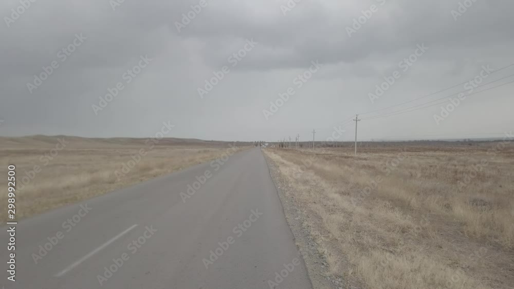 autumn auto road in the middle of the fields of Kazakhstan autumn auto road in the middle of the fields of Kazakhstan
