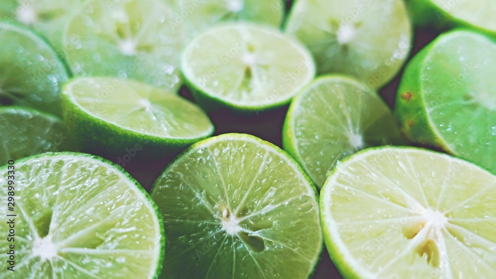 Lime Background. Close up shot of limes. Selective Focus of sliced lime. Lime is a kind of fruit. The result is very sour for cook the Thai food style