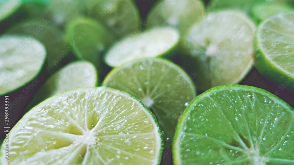 Lime Background. Close up shot of limes. Selective Focus of sliced lime. Lime is a kind of fruit. The result is very sour for cook the Thai food style Lime Background. Close up shot of limes. Selective Focus of sliced lime. Lime is a kind of fruit. The result is very sour for cook the Thai food style