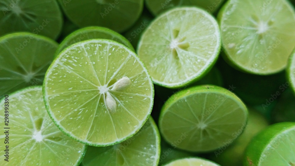 Lime Background. Close up shot of limes. Selective Focus of sliced lime. Lime is a kind of fruit. The result is very sour for cook the Thai food style