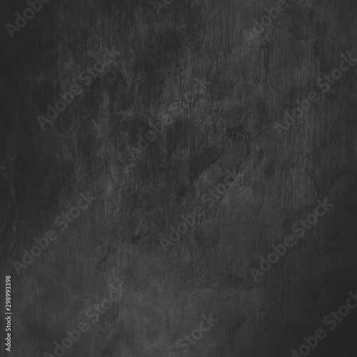 abstract black background design or old charcoal gray paper with vintage grunge border texture and soft lighting on center