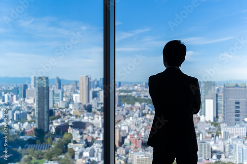 Wall Mural businessman wearing suit looking cityscape of tokyo
