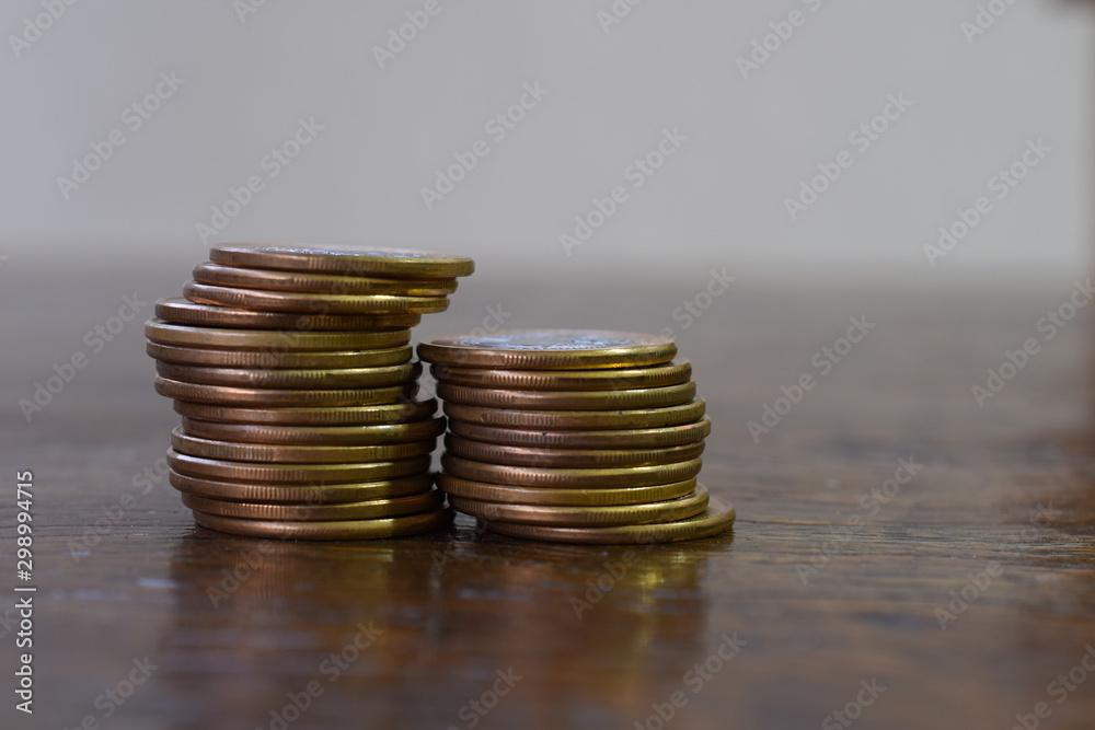 two stacks of coins on wooden table two stacks of coins on wooden table