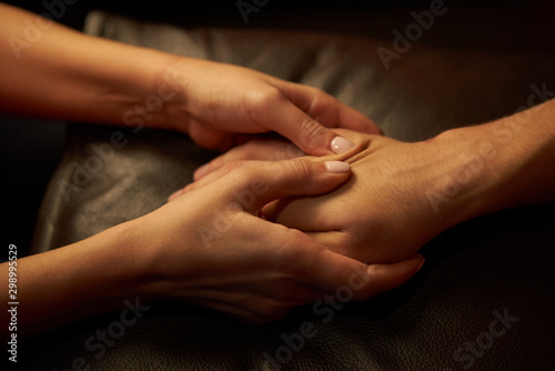 A woman does acupressure fingers for a man. hand massage with intimate lighting. Prelude before making love. Close. Complete relaxation photo