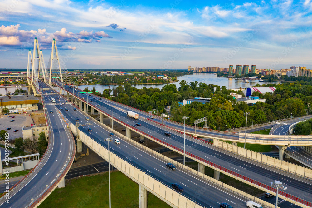 Saint-Petersburg. Russia. Traffic. Obukhov bridge across the Neva. Vansu bridge. The highway passes over a bridge. Highway. View of St. Petersburg from the drone. Road junction.