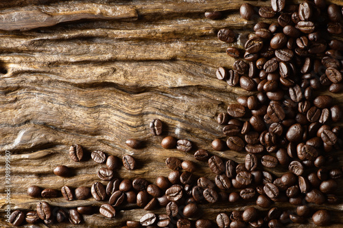 beverage background of roasted coffee beans on wooden plank