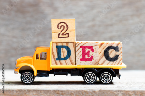 Truck hold letter block in word 2dec on wood background (Concept for date 2 month December) photo