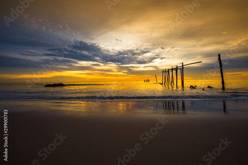 The blurry background of the colorful night sky on the large lake, the brightness of the light that hits the water surface and the wind blows cool, with the rotten wooden bridge over time, a viewpoint