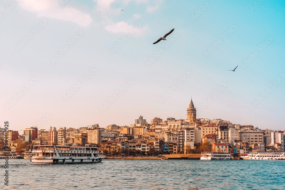 Fototapeta premium View of Istanbul cityscape Galata Tower with floating tourist boats in Bosphorus ,Istanbul Turkey