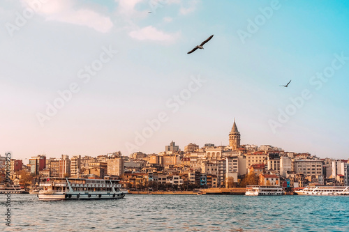View of Istanbul cityscape Galata Tower with floating tourist boats in Bosphorus ,Istanbul Turkey