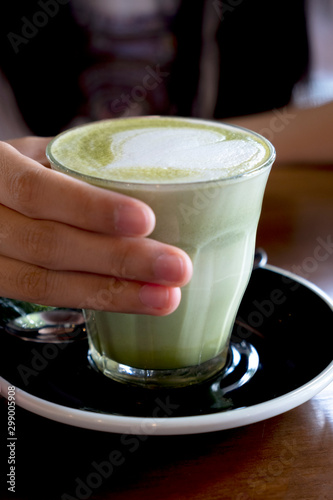 Wallpaper Mural Hot green tea latte on a wooden table top Torontodigital.ca