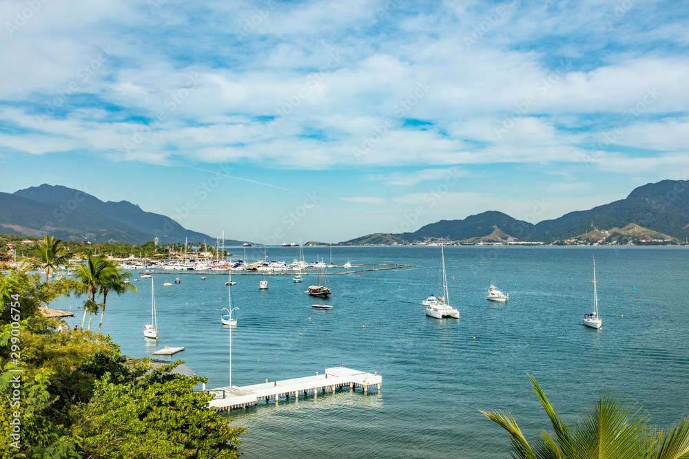 Boat and Yachts on the Coastline in Ilhabela, Sao Paulo on a Beach on the Island, Brazil Coastal Boat Boat and Yachts on the Coastline in Ilhabela, Sao Paulo on a Beach on the Island, Brazil Coastal Boat