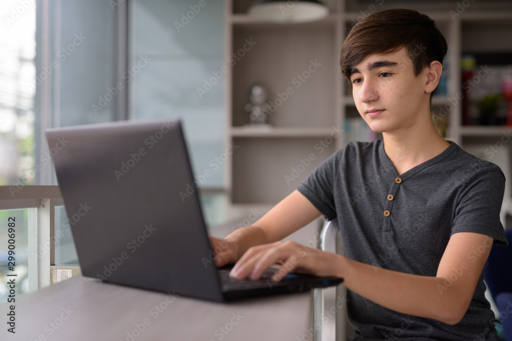 Young handsome Iranian teenage boy relaxing at home Young handsome Iranian teenage boy relaxing at home